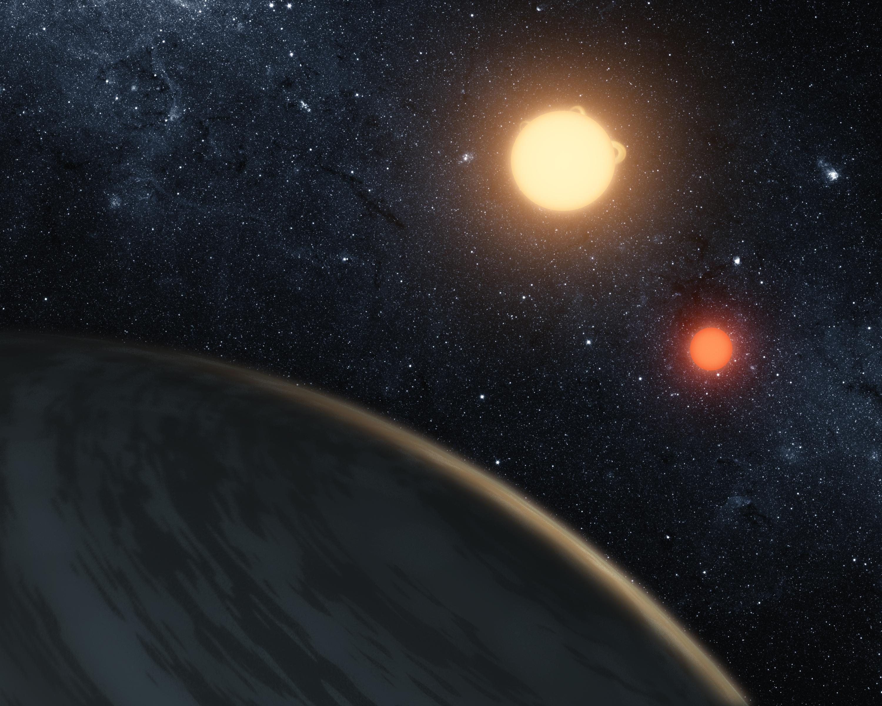 Artist's concept of the circumbinary planet Kepler-16b: a gas-giant world lit by two stars, a golden sun and a smaller red dwarf, over a dense starfield (NASA/JPL-Caltech).